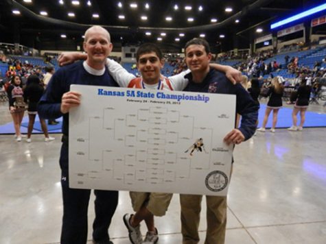 BRYANT GUILLEN stands with Coach Patrick Kelly and Assistant Coach Flores after placing first at State.  Guillen earned a 4-0 record and a state title in the 160 lb. weight class.  (Photo by Heather Guillen-Woltje)  