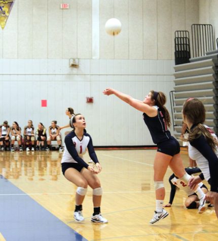 Libero Payton Summers digs the ball during a match at home. 