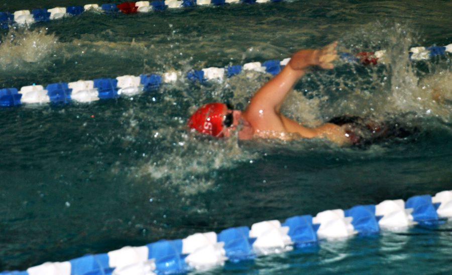 Senior Conner Henderson comes up for a breath during his 100 freestyle swim. (Photo by Karsen McCarter)