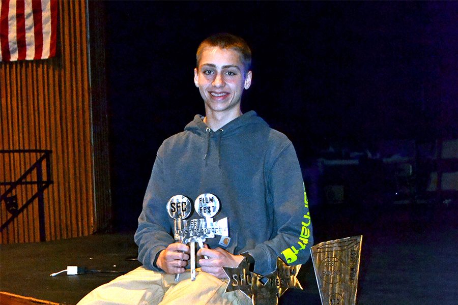 BUSY BOY Sophomore Collin Underwood poses with the trophies he made. He would spend over 10 hours on them.