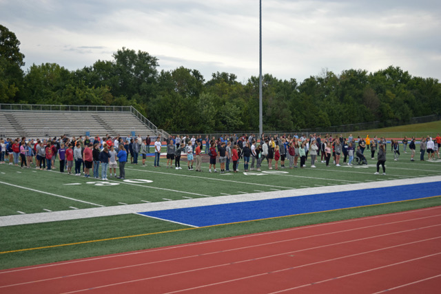 The+Senior+Class+gathers+in+the+football+stadium+to+create+a+giant+100+celebrating+the+100th+class+of+Seaman+High+School.+Anna+Kennedy%2C+one+of+the+band+directors%2C+organizes+the+Vikings+into+formation.