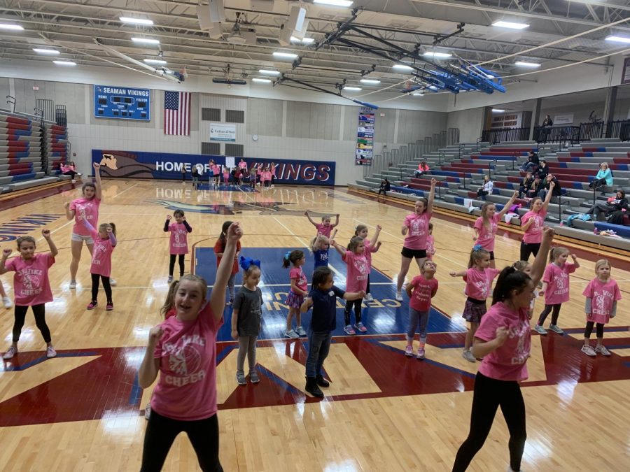 SHS cheerleaders teach elementary schools kids a dance. Jr. Vikes are preparing to perform at the game 