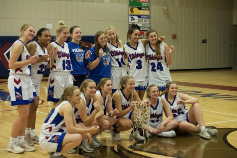 The Lady Vikes pose for a final picture after cutting down the net. The team celebrated their performance at the state tournament despite the premature end due to Covid-19.