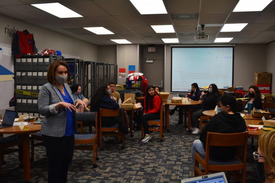 Administrator Danira Fernandez-Flores speaks to students about identifying themselves through name tags. The main meeting discussion would surround emotions encompassing the possibility of a district name change.