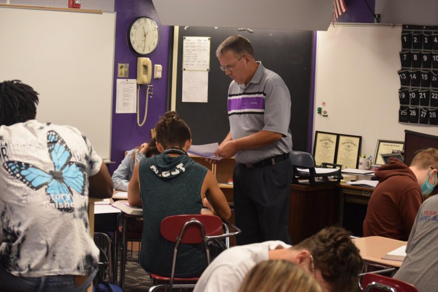Mr. Blackman helps a student work through a math problem. Blackman relaxes into his role as returning math instructor.