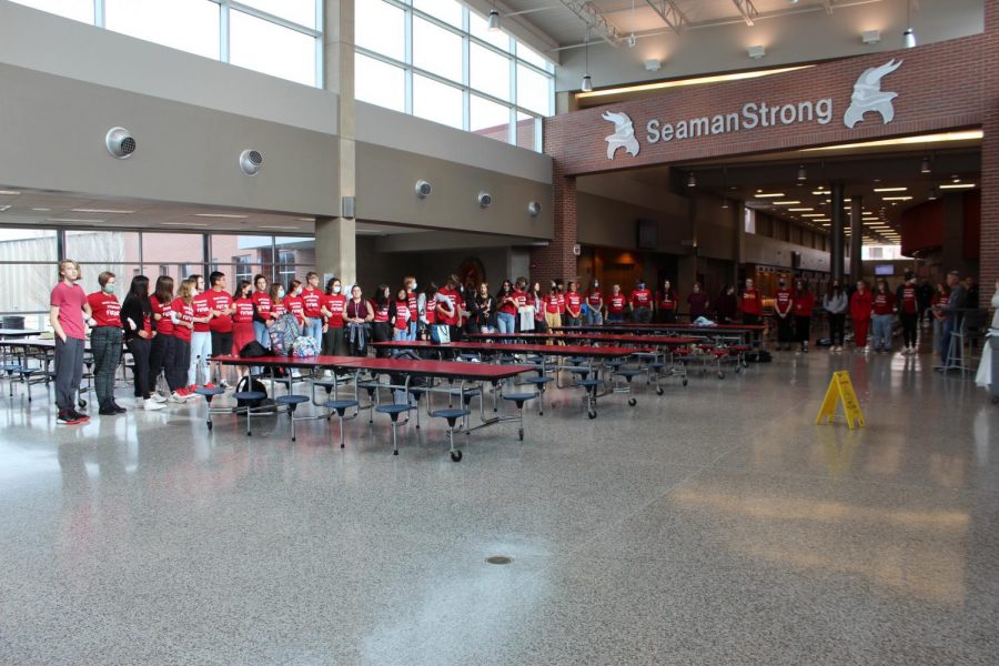 Students in support of renaming the school district gather in the freshman commons. They stood peacefully, interlocking arms, and wearing red.