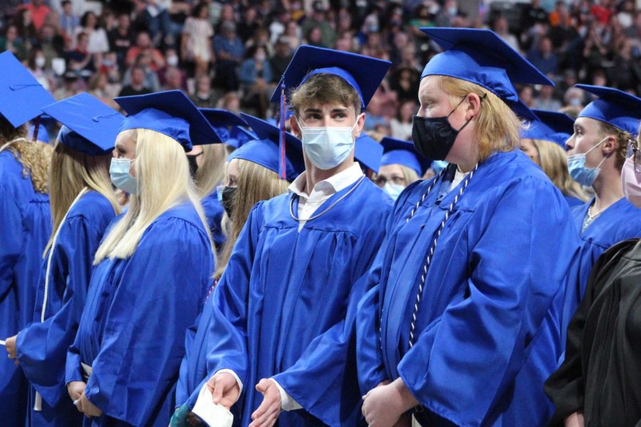 Seniors Kyle Adams and Bradley Acree talk during the graduation ceremony on May 23, 2021. The Class of 2021 had two and a half normal years of high school before the COVID-19 pandemic hit.