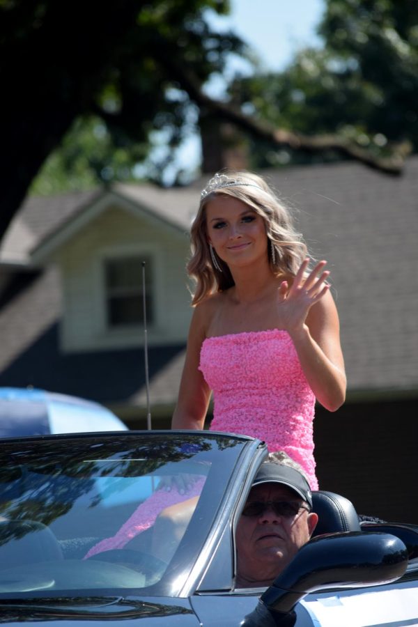 Homecoming candidate Avary Polter waves to the photographer while riding through the Homecoming parade. Last year, due to the pandemic, the Homecoming parade was cancelled, along with other annual Homecoming traditions like the bonfire and dance.