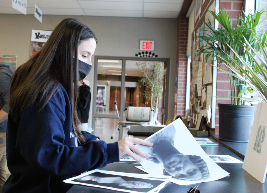 Sophomore Adyson Cashman files through pages of designs, wondering which page she should chose to print. On January 27, 2021, the new Printmakers club, started by art teacher Mr. LeDuc, met and made prints of either their own artwork or already printed out designs.