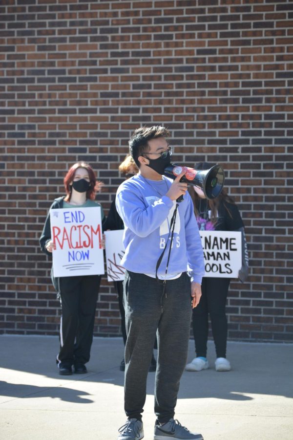 Junior Kevinh Nguyen uses a meghaphone to project his speech to the Rename USD 345 protesters. I attended because it was a moral obligation to myself and those who worked for racial equality in the past, if I didnt, then I would be a bystander of injustice, Nguyen stated.