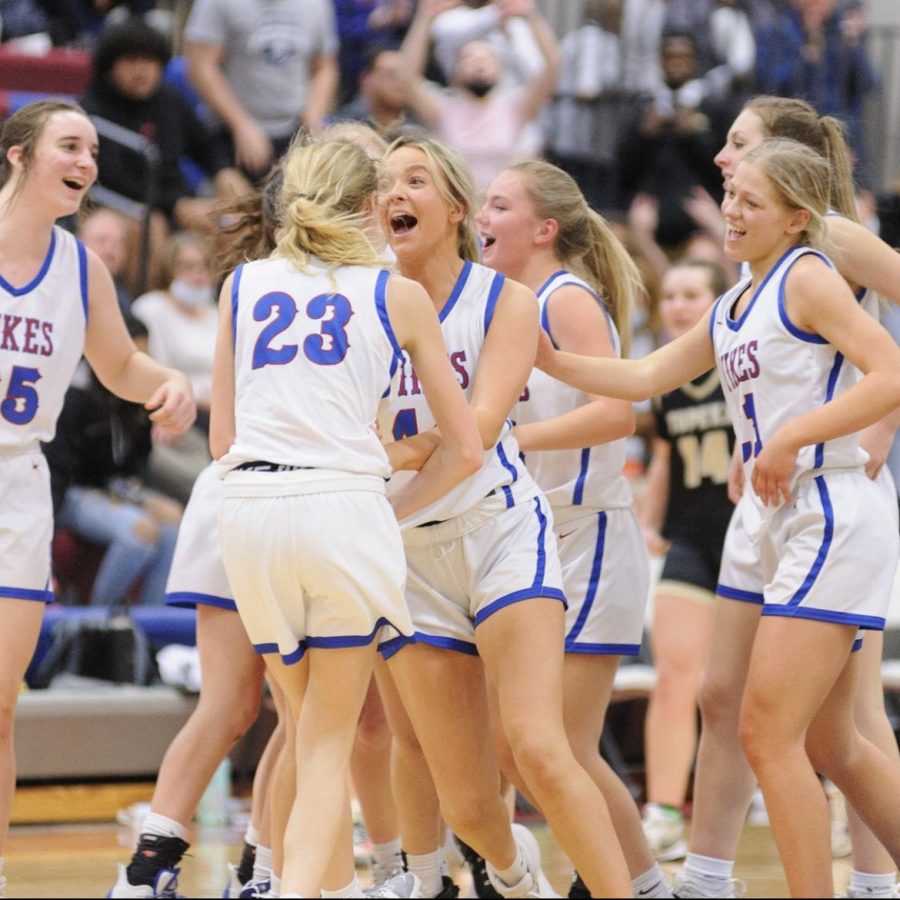 The+Lady+Vikes+run+to+each+other+to+celebrate+after+winning+the+Feb.+15%2C+2022%2C+game+against+the+Topeka+High+Trojans+50-42.+The+Vikings+stole+the+undefeated+title+from+the+Trojans%2C+who+were+16-0+coming+into+this+game.+
