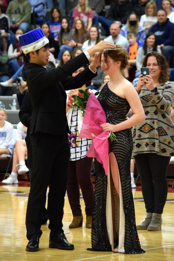 Senior and Snowball King Tuan Vu fixes newly crowned Snowball Queen Hannah Motts tiara after it tipped forward between the boys and girls basketball game on Feb. 18, 2022. 