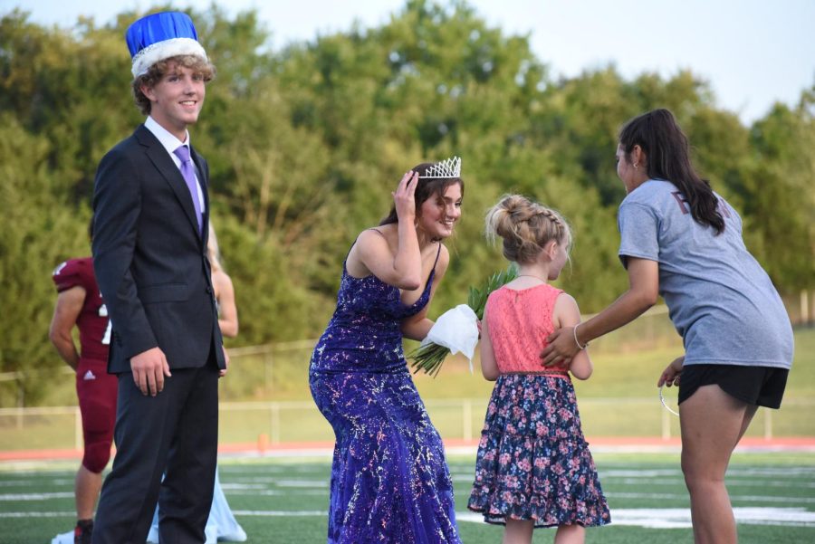 Homecoming Queen Reagan Carter smiles after getting her tiara placed on her head, while Homecoming King Anson Appelhanz looks towards the crowd who was roaring in excitement at the newly added royalty.