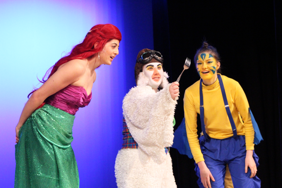 Ariel (senior Ellie Noble) and Flounder (sophomore Anna Sage) gather around Scuttle (senior Bailey Alt) who explains the purpose of a new object Ariel found from the above world; a dinglehopper. The SHS Theater presented The Little Mermaid: the Musical on Mar. 24, Mar. 25, and Mar. 26, 2022. Alt said, “I love that I got to do my last musical with the people I did it with. I was such a place of love and I made friendships with everyone. This show was amazing and I wish I got more time with everyone.”
